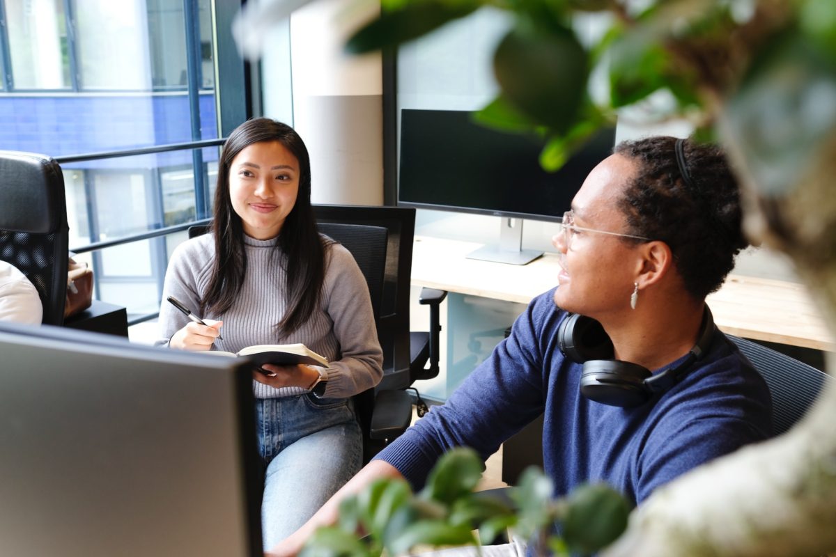 A web designer and a UX designer discussing a project